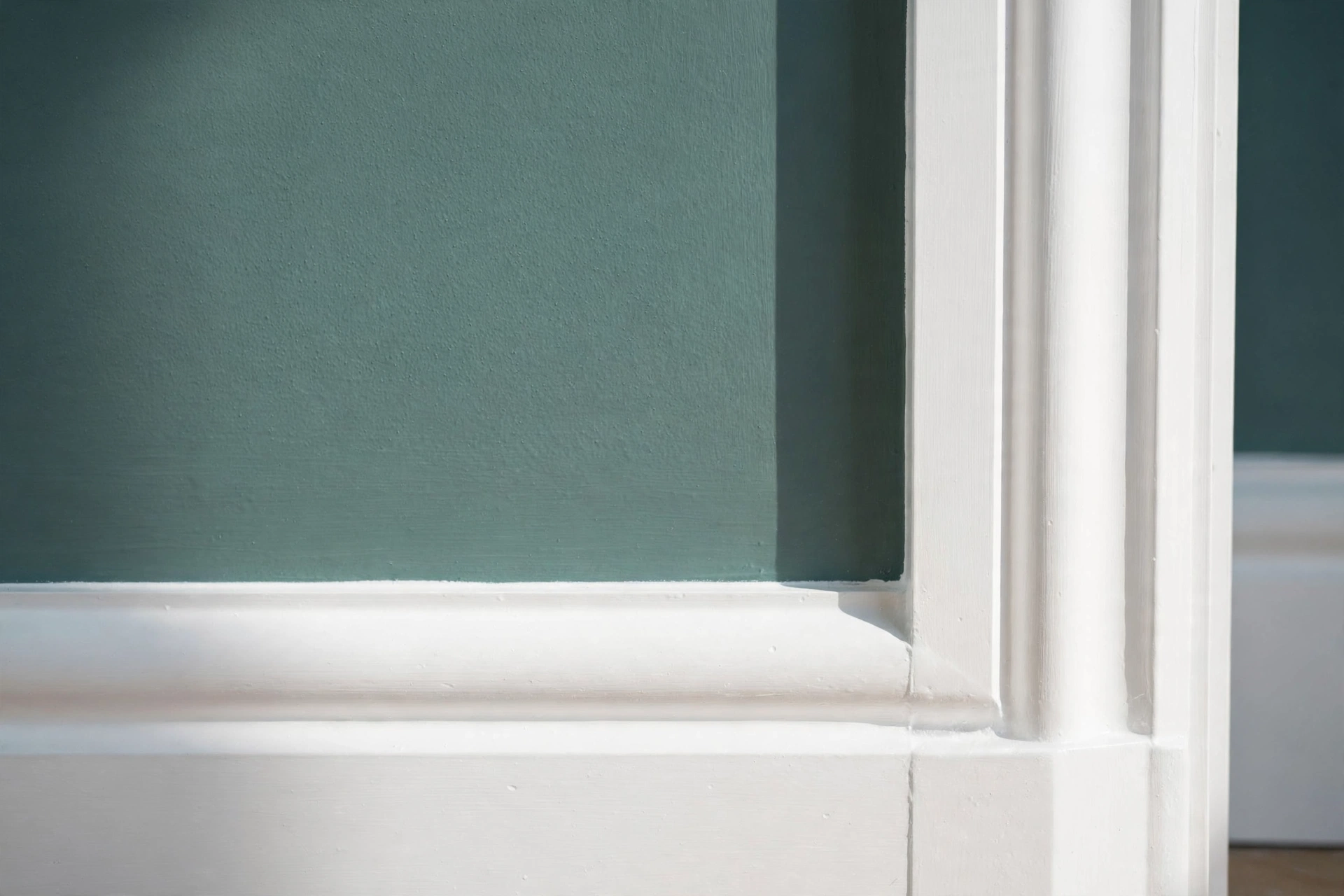 Freshly glossed skirting boards and panelled internal door